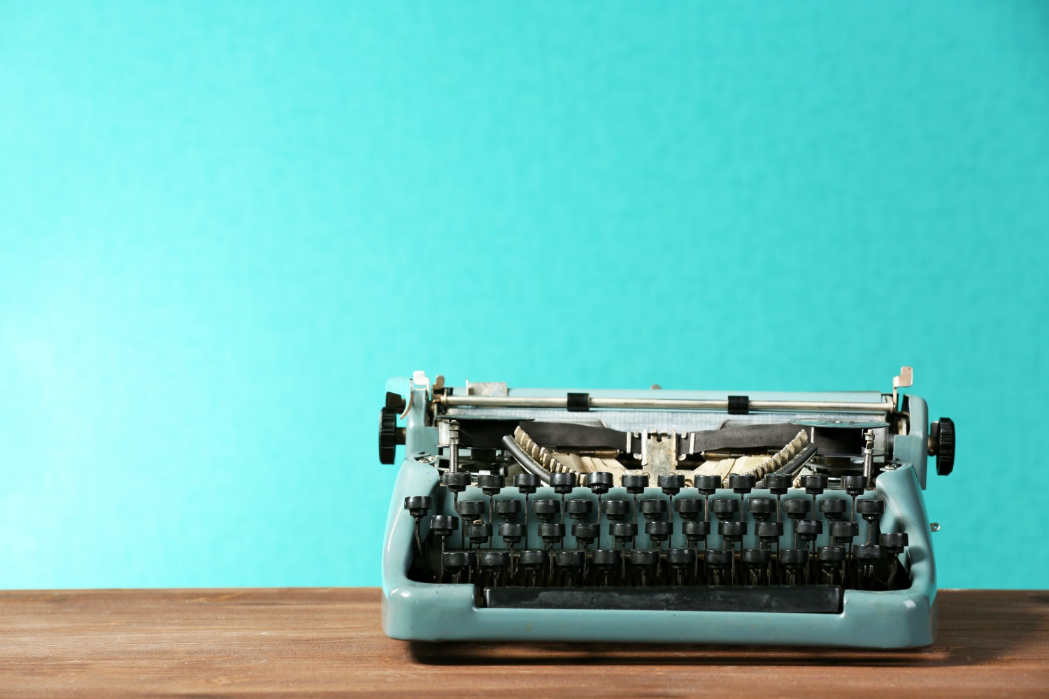 Old retro typewriter on table on green background